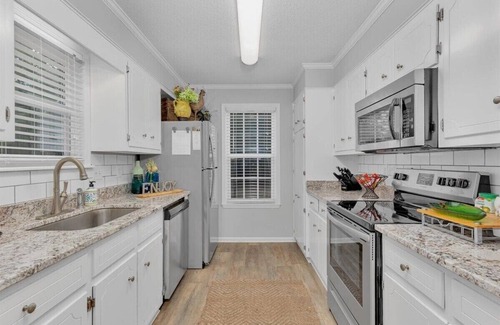 National Hills House | 2-bedroom home with 1.5 bathrooms and fully fenced backyard. The sleeping arrangements are 1 king bed and 1 queen bed.