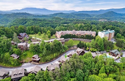 Pigeon Forge House | 2 Miles from Dollywood Family Resort with Seasonal Outdoor Swimming Pool, Year around Heated Indoor Swimming Pool, Townhome Style Cabin, Private Hot Tub, Arcade, TV, Wifi, Kitchen with Refrigerator, Washer and Dryer