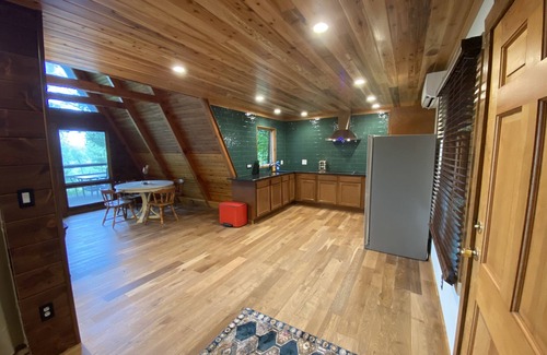 Allegan House | A-frame cabin nestled in forest, stunning lake view, perfect serenity.