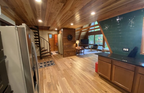 Allegan House | A-frame cabin nestled in forest, stunning lake view, perfect serenity.