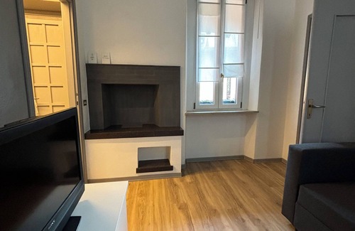 Treviglio Apartment | Apartment with a terrace among the rooftops of an old building.