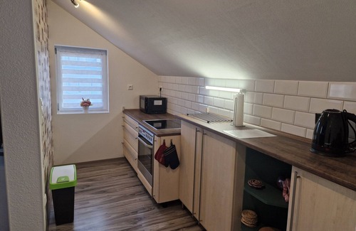 Burg Stargard Apartment | Apartment without fireplace in the attic - Onkmangani Appartmenthaus Oelschläger