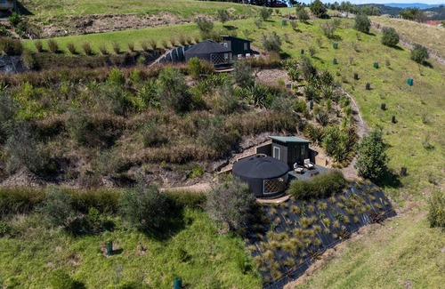 Palm Beach Cabin | Awaawa Yurts - Papa Yurt - Awaawa Yurts offer a luxury glamping experience on Waiheke Island. Stunning views, luxury queen sized bed, private bathroom with tea and coffee making facilities.