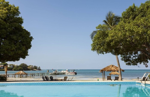 Carenero Apartment | Beachfront Dream! White Sand Beach, Pools, Family-Friendly, Parking!