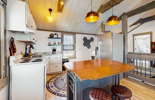 Arbor Vitae Cabin | Charming lakefront cabin with fireplace, cozy interior, streaming, & partial AC
