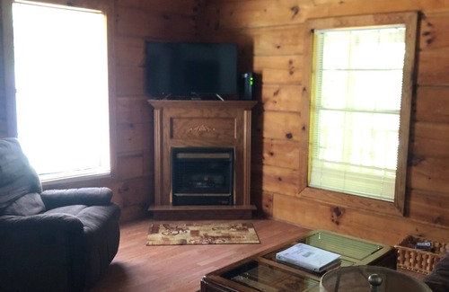 Oneida Cabin | cozy cabin in the woods in a relaxing area with wrap around porch rocking chairs