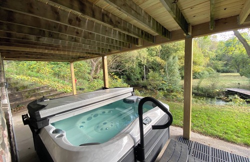Pentwater Cabin | Cozy cabin on the serene Pentwater River with hot tub and ac