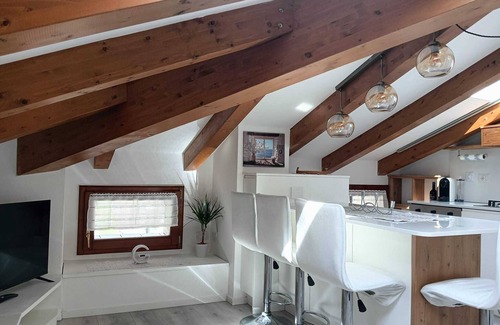 Levico Terme Apartment | Elegant attic with Dolomites view, relaxation and nature in Levico Terme.