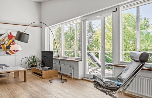 Daugard House | Enjoy a relaxing holiday in this holiday home with sea views near Vejle Fjord.