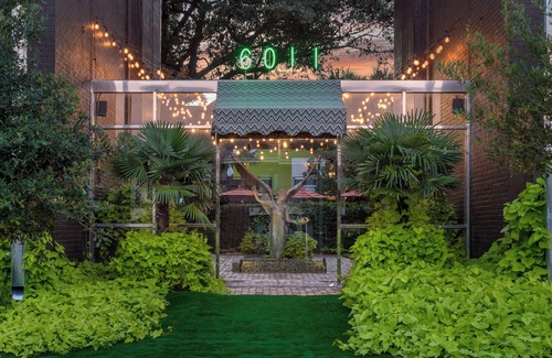 Lower Greenville Condo | Experience elevated comfort in this upscale 2-bedroom Dallas condo with pool views and exclusive access to an award-winning courtyard featuring a resort-style pool, hot tub, dry sauna, and lush lounge areas. Enjoy a 77″ smart TV, sleek leather sofa,