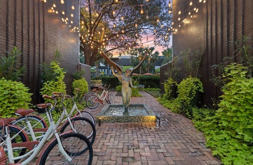 Lower Greenville Condo | Experience elevated comfort in this upscale 2-bedroom Dallas condo with pool views and exclusive access to an award-winning courtyard featuring a resort-style pool, hot tub, dry sauna, and lush lounge areas. Enjoy a 77″ smart TV, sleek leather sofa,