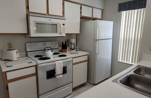 Royal Palm Bay Condo | Ground floor, With a pond view patio.