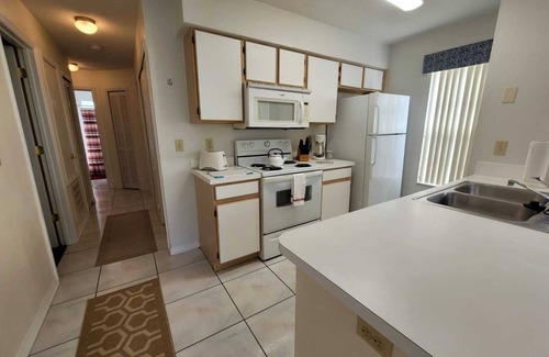 Royal Palm Bay Condo | Ground floor, With a pond view patio.