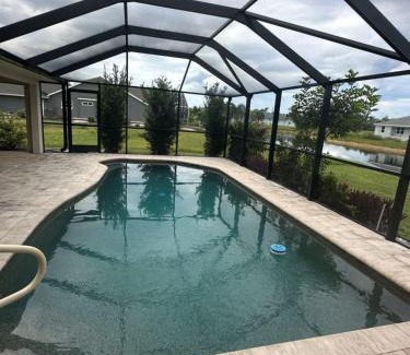 Pebble Beach House | Heated pool with canal views