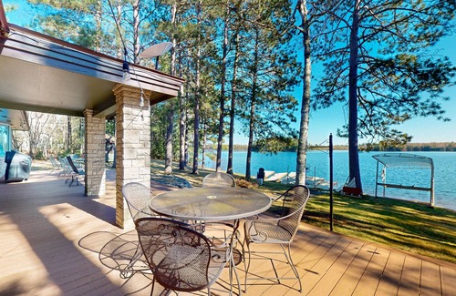 Lac du Flambeau House | Lakefront house with private covered hot tub, dock, wood fireplace, & firepit