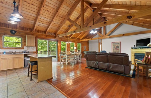 Zoe Cabin | Log Home with fenced in deck & screen porch, cosmopolitan style ranch design.
