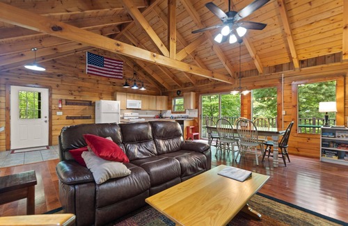 Zoe Cabin | Log Home with fenced in deck & screen porch, cosmopolitan style ranch design.