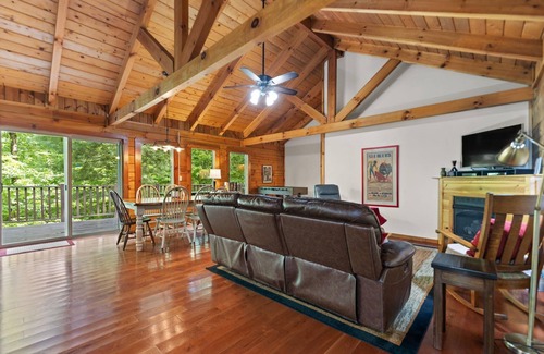 Zoe Cabin | Log Home with fenced in deck & screen porch, cosmopolitan style ranch design.
