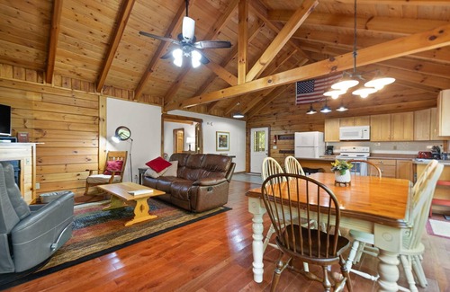 Zoe Cabin | Log Home with fenced in deck & screen porch, cosmopolitan style ranch design.