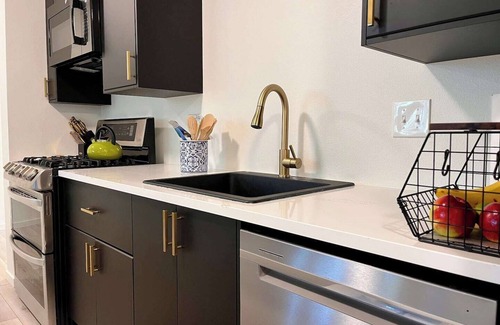 Loveland House | Nestled on the Marianna Butte Golf Course in Loveland, this modern garden-level basement retreat offers stunning mountain & lake views through large windows, flooding the space with light. Just a short drive to CSU campus & Estes Park