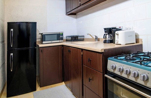 St. Lawrence Gap Apartment | Poolside Studio, Shared Patio and Hotel Amenities