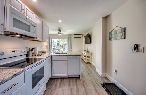 South Island House | Sand Dollar #2 - Downstairs Apt w Shared Pool on Canal by the Beach!