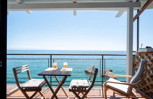 Spisone Apartment | Sea view apartment of about 90 sqm, able to accommodate up to 4 people, located on the ground floor of a building.The property is located in Taormina, in a unique panoramic position, suspended above a rock and with the beach right in front of the apartme
