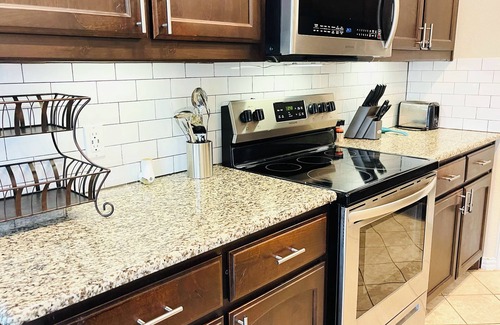 Ennis House | Spacious 5 Bedroom Home, Huge Swim Spa & Private Theater with Popcorn Machine!