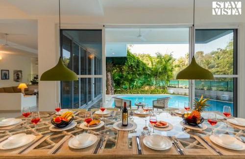 Mandrem Villa | StayVista at Aroha Palms Paradiso - Pool, Wi-Fi