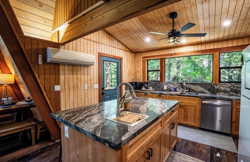 Sierra Cedars Cabin | Tucked in the trees, Cedar Hill is a cozy A-frame cabin with modern updates, a spacious kitchen, wraparound deck, and stunning views. The perfect mountain escape for families, couples, and friends—plus, it's pet-friendly!