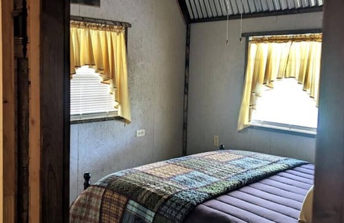 Jasonville RV Rental | Unique 14x40 Cozy cabin with large front Deck That overlooks the water.