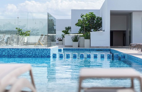 Gonzalo Guerrero Condo | Unit B: A Stylish Beachside Escape Featuring Four Rooftop Pools, a Large Gym, Bar, Restaurant, Kids Club, and Spa