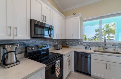 Breezeswept Beach Estates House | Villa Lucie | Canalfront home w/5 bedrooms + pool + boat lift