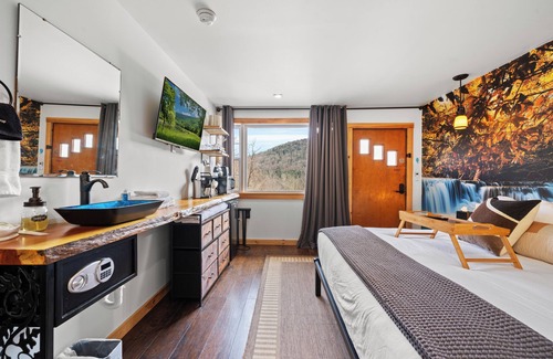 Hancock Hotel | Waterfall Retreat | Serene Room with Forest Mural at Green Acres Retreat