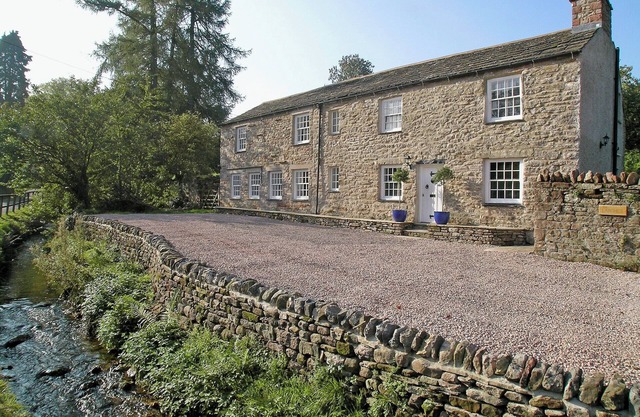 A spacious detached cottage located by a beck in a quiet village.