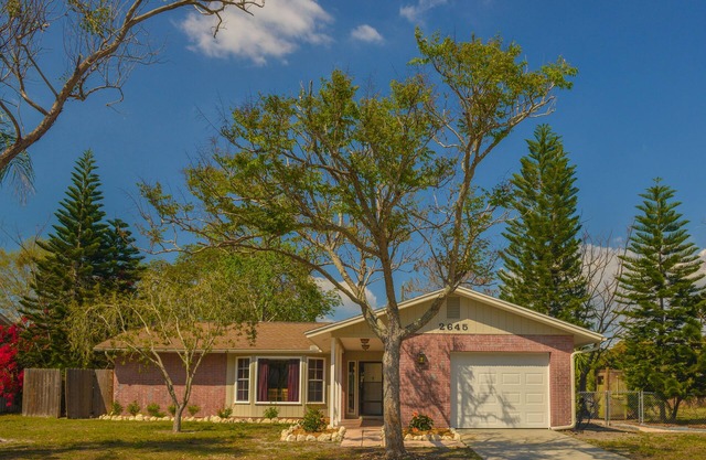 Charming Florida bungalow with pool and fenced-in yard.