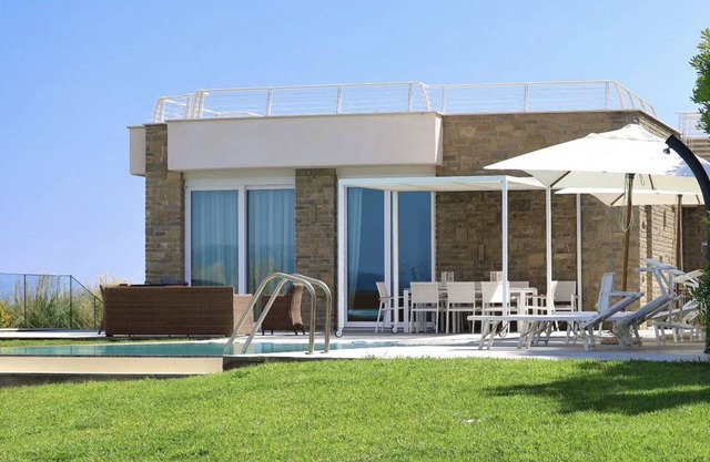 Design beachfront villa, private pool, a/c, WiFi, garden and parking space