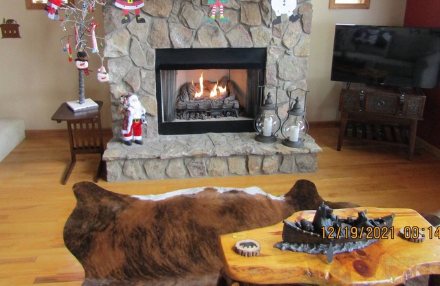 Enjoy the view of several mountain ranges from the deck looking over the trees.