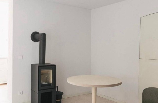 GARDEN FLOOR EAST: wood-burning stove and terrace to the southeast