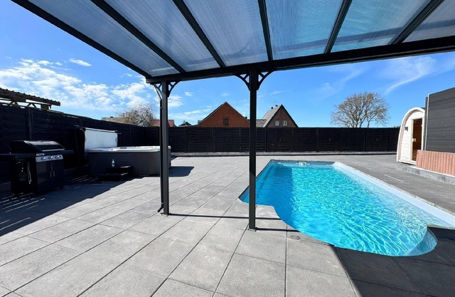 Holiday home with private hot tub and air conditioning.