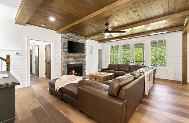 Modern lakefront retreat with private dock, game room, grill, & boat access