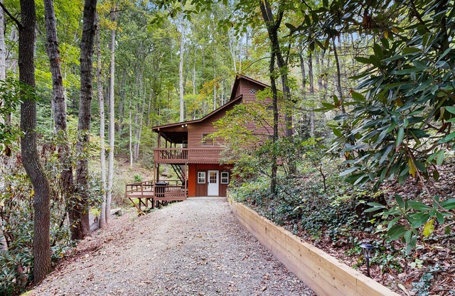 Mountain home nestled in the forest with a stream, deck, firepit, & game room