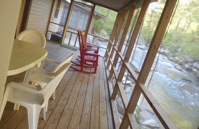 On the River's Edge! Rocking chairs on large screened porch on river's edge.