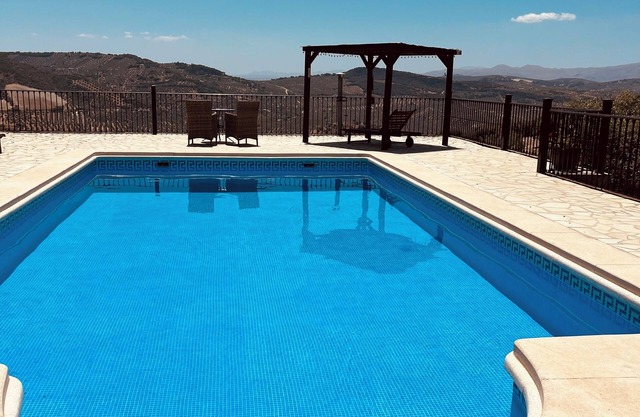 Private, hillside cottage with spectacular views, air con & secluded pool.