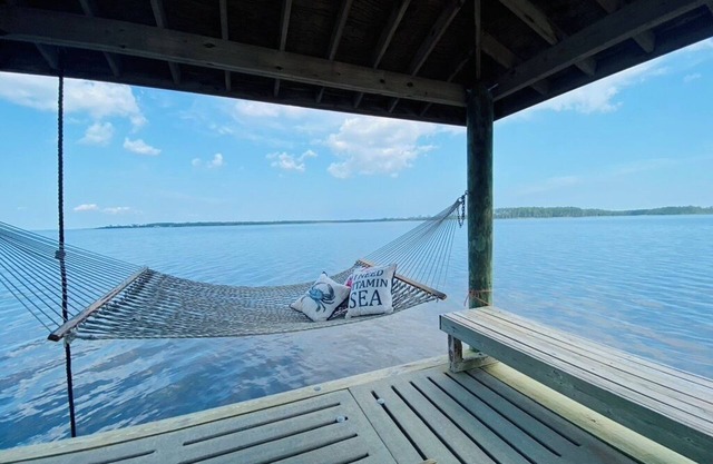 Riverfront property with dock and ramp. Dolphins, fish, boat, swim & more