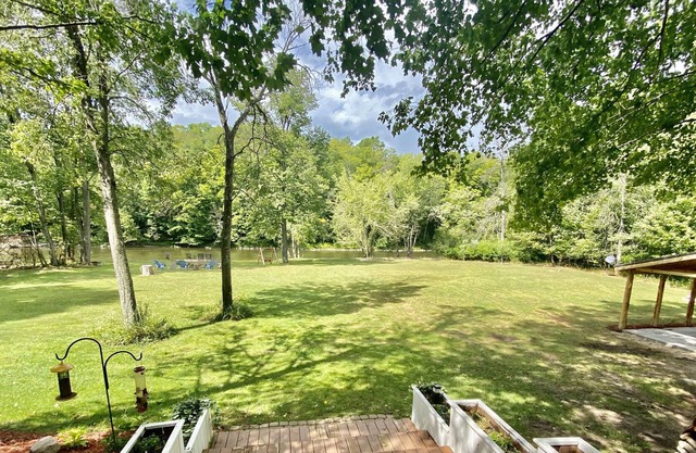 Rustic large luxury home with 300 feet of riverfront surrounded by woods.