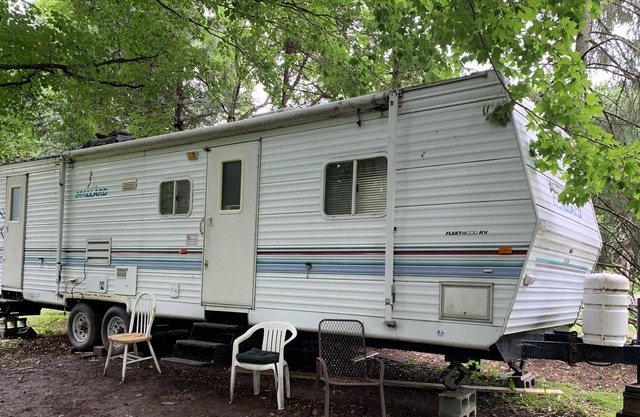 RV slide out wooded country setting