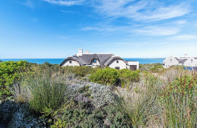 Spectacular ocean view with vibrant fynbos in the foreground.