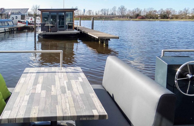 Spend a wonderful vacation on the water in this modern houseboat.