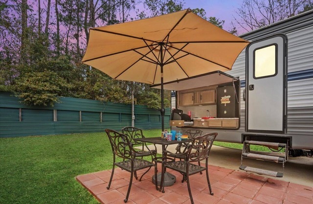 Super- fun camper with plenty of room for a full-size family, lots of comfy beds + full kitchen, bath, and separate bedroom for Mom & Dad. There's even a nice patio with outdoor kitchen and seating area for barbecues, bacon & eggs in the morning, et